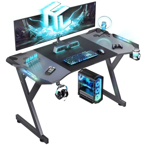 HLDIRECT 47 Inch Gaming Desk with LED Lights, Ergonomic Computer Table with Carbon Fibre Surface, Sturdy PC Workstation Desk for Home Office with Headphone Hook, Cup Holder, Black